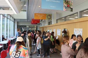 hallway full of students presenting posters