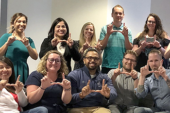 group of individuals flashing the u