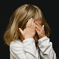Little Girl with Hands Covering Face