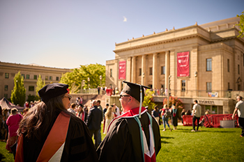 recent graduates standing in front of kingsbury hall