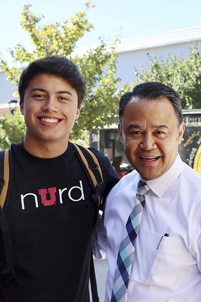 a male student standing next to dean laanan smiling at camera