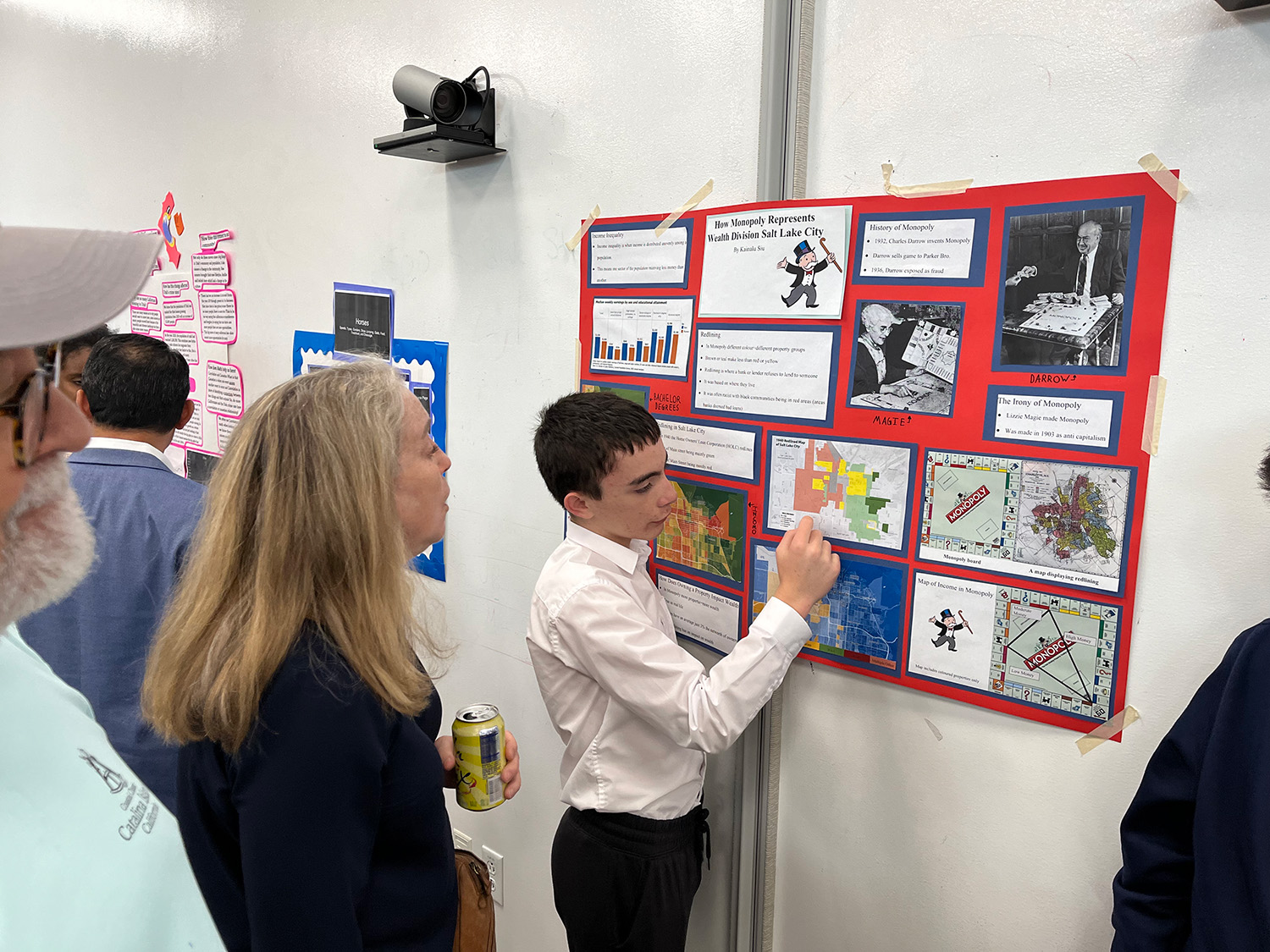 Student shows his research to parents. 