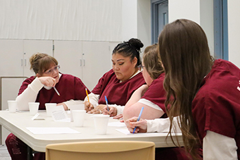 group of inmate students discussing coursework